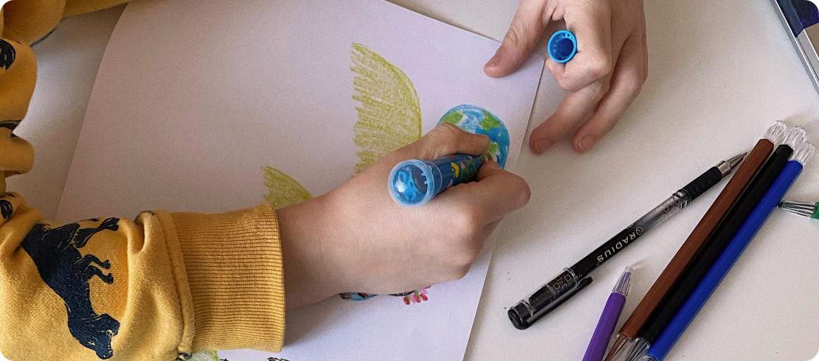 Child drawing with crayons